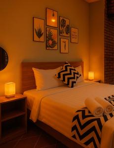 a bedroom with a large bed with two lamps on it at Hy Viên boutique Garden & Swimming pool in Cồn Giả Viên