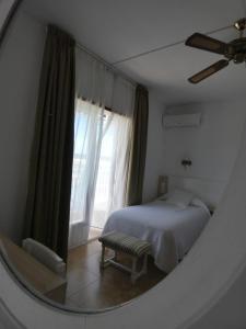 A bed or beds in a room at Hostal Port Fornells