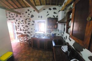 a kitchen with a cow pattern on the wall at Casa Brum in Santana