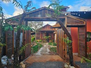 an archway leading to a house with a garden at Riverside in Hòa Bình