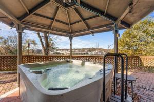 a hot tub in a gazebo on a deck at Lake Shore Landing - For 20 in Branson