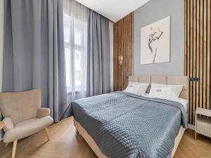 Postel nebo postele na pokoji v ubytování WSCHODNIA ELEGANS Aparthotel