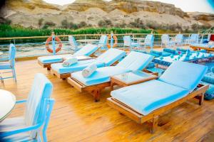 a bunch of lounge chairs and tables on a boat at دهبيه كوين شارلوت in Luxor +2 photos