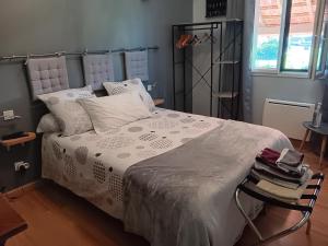 a bedroom with a bed with white sheets and pillows at La Guette in Cercy-la-Tour
