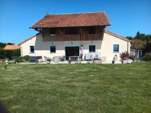 a large white house with a large yard at La Guette in Cercy-la-Tour