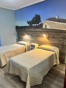 Posteľ alebo postele v izbe v ubytovaní Hostal imperio
