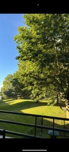 a view of a golf course with trees and grass at Appartement Cosy in Fresnes