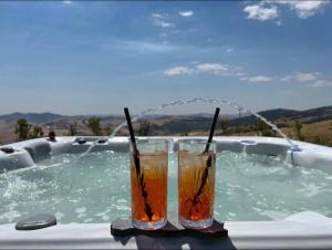 two drinks sitting on a table in a jacuzzi tub at MonteSoprano Agriturismo - Resort - Spa - Gym -Camping - Suite in Capizzi +79 photos