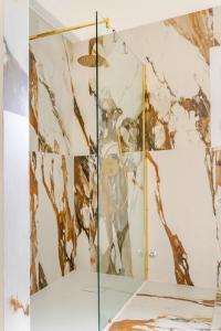 a shower with a glass door in a bathroom at Maison Genoli - 3 chambres et 3 salles de bain in Ceglie Messapica