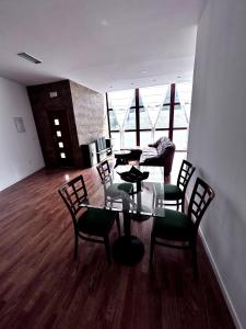 a dining room with a table and chairs and a couch at La estación in Villafranca del Bierzo