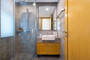 a bathroom with a sink and a shower at 三亚亮庭观棠独享别墅 in Sanya +34 photos