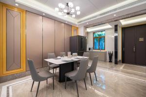 a dining room with a table and chairs at 三亚亮庭观棠独享别墅 in Sanya