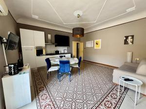 a kitchen and a living room with a table and chairs at Mid Modern Akragas Home in Center with Sea View in Agrigento