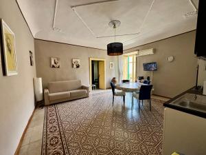 a living room with a table and a couch at Mid Modern Akragas Home in Center with Sea View in Agrigento