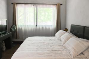 una camera da letto con un letto grande con una finestra di Hotel Boutique Canto De Piedra a Tamasopo
