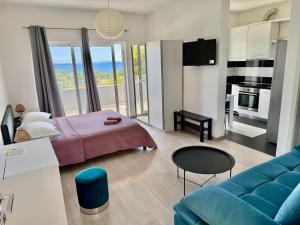 a living room with a bed and a couch at Apartments ŽAJA in Seget Vranjica