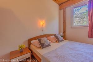 a bedroom with two beds and a window at Galeb in Kustići