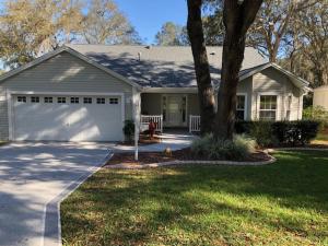 a white house with a tree and a garage at 119 Z2b VILLAGE LA ZAMORA by REMAX Premier in The Villages
