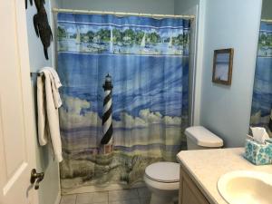 a bathroom with a shower curtain with a lighthouse at 119 Z2b VILLAGE LA ZAMORA by REMAX Premier in The Villages +25 photos