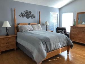 a bedroom with a large bed with a wooden headboard at 119 Z2b VILLAGE LA ZAMORA by REMAX Premier in The Villages
