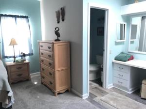 a room with a bedroom with a dresser and a bathroom at 1142 Z1 VILLAGE OF ORANGE BLOSSOM by REMAX Premier in The Villages +27 photos