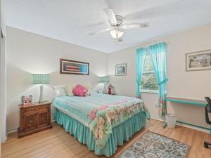 a bedroom with a bed and a ceiling fan at 1632 Z1 Village of Orange Blossom Gardens by REMAX Premier in The Villages