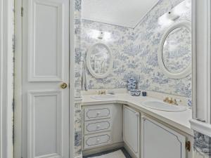 a bathroom with two sinks and two mirrors at 1705 Z1 Village of Orange Blossom Gardens by REMAX Premier in The Villages +17 photos