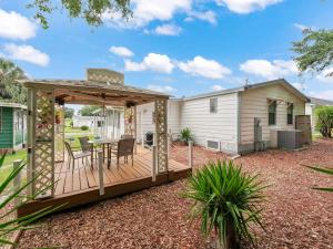 a deck with a gazebo and a house at 1705 Z1 Village of Orange Blossom Gardens by REMAX Premier in The Villages