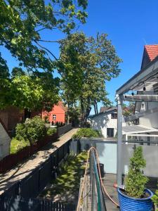 a house with a garden with a hose at Nadmorska Miła in Gdańsk