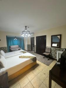 a large bedroom with a large bed and a couch at New Star Zamalek Hotel in Cairo +53 photos