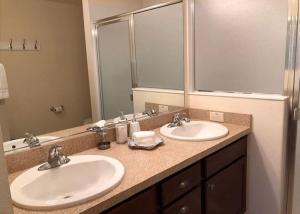 a bathroom with two sinks and a large mirror at 2474 Z3a VILLAGE OF ST JAMES by REMAX Premier in The Villages +20 photos