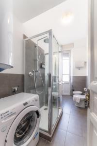 a washing machine in a bathroom with a shower at Elegant Apartments Palumbo in Rome +35 photos