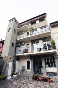 a white building with balconies and potted plants at New Ulivo Apartment 2 in Seriate