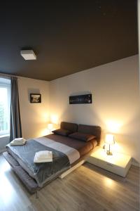 a bedroom with a large bed with two lamps at New Ulivo Apartment 2 in Seriate