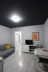 a living room with a couch and a tv at New Ulivo Apartment 2 in Seriate
