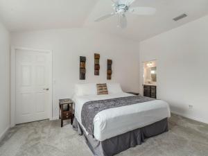 a white bedroom with a bed and a ceiling fan at 5049 Z6 VILLAGE OF MARSH BEND by REMAX Premier in The Villages