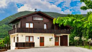 a building with a sign on top of it at Apartments Bramado in Seliste Dreznicko