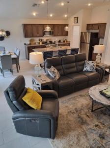 a living room with a couch and a kitchen at 3 Bedroom 2 Bath Designer in The Villages
