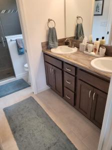 a bathroom with two sinks and a mirror at 5991 Z5 VILLAGE OF ST. CATHERINE by REMAX Premier in The Villages +11 photos
