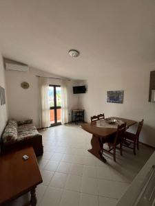 a living room with a table and a couch at Casa Giuli in Villasimius