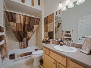 a bathroom with a sink and a toilet and a tub at 786 Z3a VILLAGE OF HEMINGWAY by REMAX Premier in The Villages +22 photos
