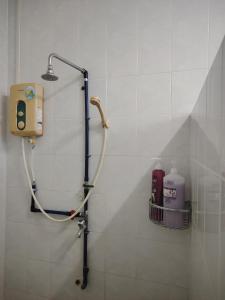 a shower in a bathroom with a soap dispenser at 22 Homestay Tenom in Tenom