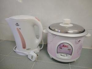 a hello kitty kettle and coffee maker sitting on the floor at 22 Homestay Tenom in Tenom