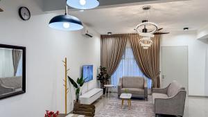 a living room with a couch and a chair at 262 Comfy Luxury Retreat with Wifi and Netflix in Port Dickson +95 photos