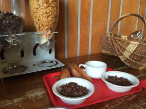 a red tray with bowls of food on a table at Auberge de Jeunesse HI Saint-Brieuc in Saint-Brieuc