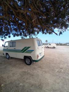 a small white van parked in a field at Vintage Camper Van Explore Driving Mallorca - full equip in Palma de Mallorca +8 photos