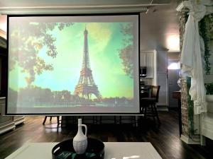 a large screen with a picture of the eiffel tower at Magnolia Farmhouse at Summerfield NC in Summerfield