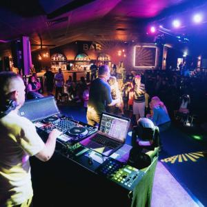 a group of people standing around a table with a dj at marine getaways caravan hire in Rhyl +86 photos