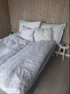 a bed with pillows on it in a room at Explorers Cabin Lofoten in Offersøya