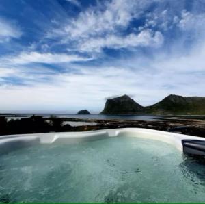 a bath tub with a view of the ocean at Explorers Cabin Lofoten in Offersøya
